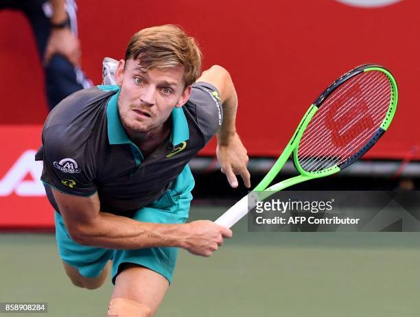 David Goffin of Belgium serves to Adrian Mannarino of France during their men's singles final match during the Japan Open tennis tournament in Tokyo...