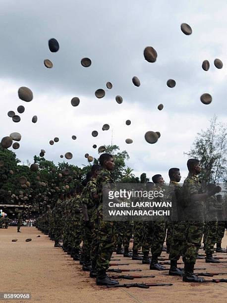 Sri Lankan Police Special Task Force commandos throw their berets in the air during a passing out parade in Katukurunda, some 43 kms south of...