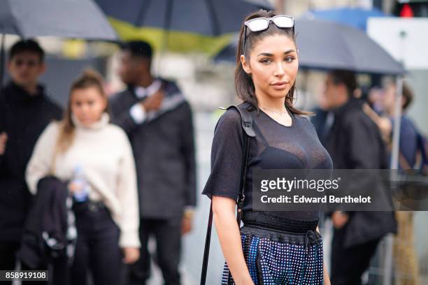 Chantel Jeffries wears sunglasses, a mesh black top, black bras, flare pants attends Le Defile L'Oreal Paris as part of Paris Fashion Week Womenswear...