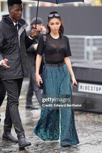 Chantel Jeffries wears sunglasses, a mesh black top, black bras, flare pants attends Le Defile L'Oreal Paris as part of Paris Fashion Week Womenswear...