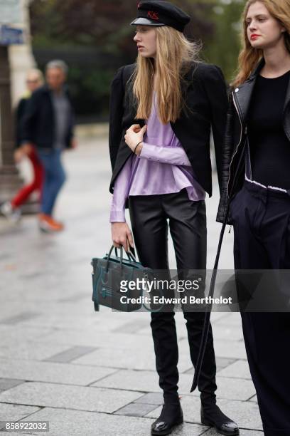 Guest wears a beret, a purple top, a black blazer, black pants, outside Le Defile L'Oreal Paris as part of Paris Fashion Week Womenswear...