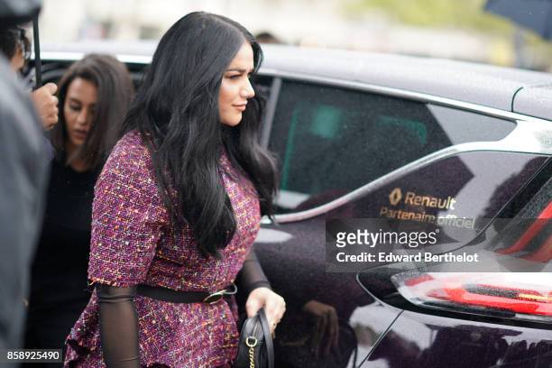 Guest wears a purple tweed dress, a belt, and attends Le Defile L'Oreal Paris as part of Paris Fashion Week Womenswear Spring/Summer 2018 at Avenue...