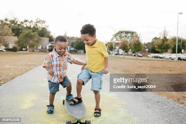trying longboard together - animal fetus stock pictures, royalty-free photos & images