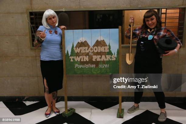 Fans in costume pose for a photograph in front of the Welcome to Twin Peaks sign during the Twin Peaks UK Festival 2017 at Hornsey Town Hall Arts...