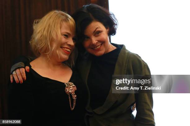 Actress Sherilyn Fenn, who portrayed the character Audrey Horne in the TV series Twin Peaks, poses with a fan dressed as Laura Palmer during the Twin...