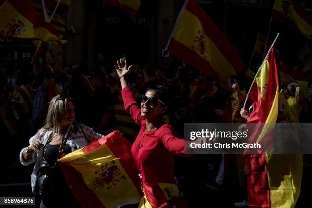 Woman dances down the street while taking part in a protest against Catalonia's indepedence on October 8, 2017 in Barcelona, Spain. Large numbers of...