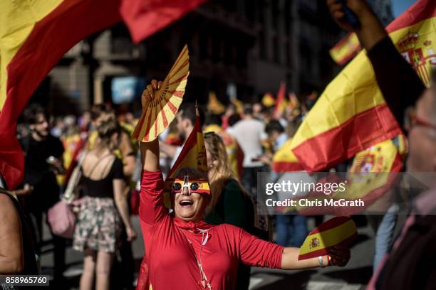 Woman dances in the street during a protest against Catalonia's indepedence on October 8, 2017 in Barcelona, Spain. Large numbers of citizens are...