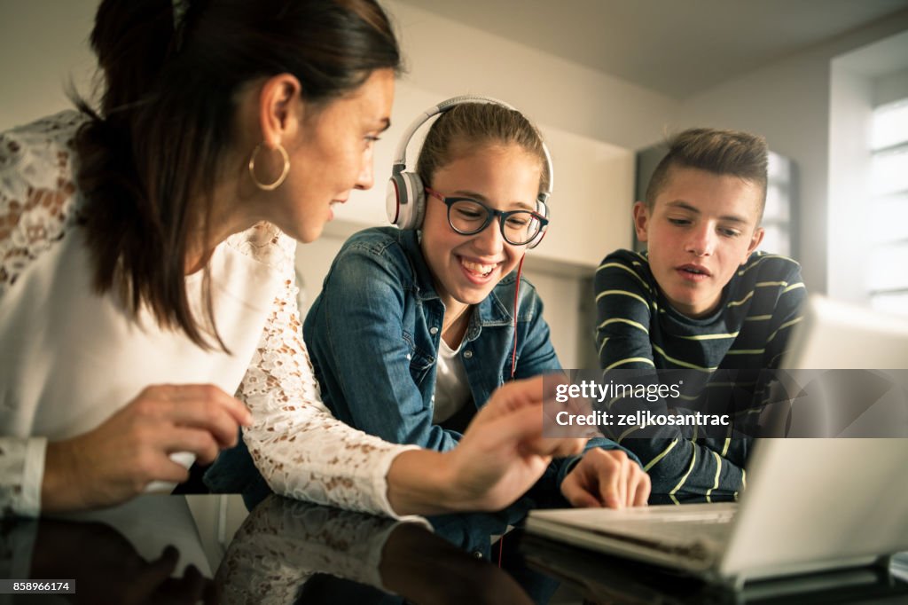 Family Using Computer 2000s Smiling Family Using Computer At Home High-Res Stock Photo - Getty Images