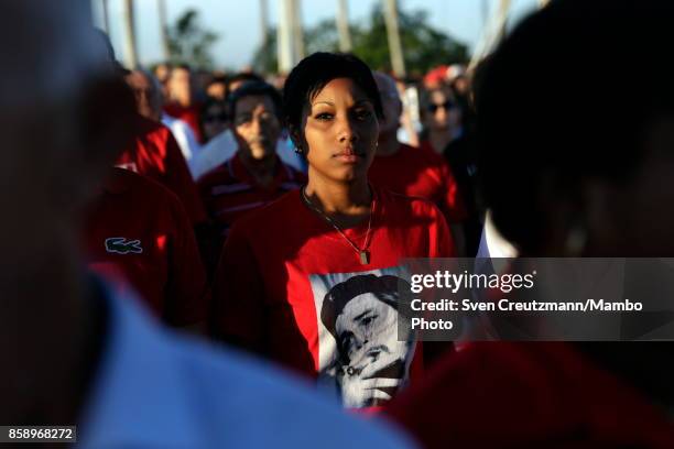 Cubans wear T-Shirts with the image of Che Guevara during a political act at the Plaza de la Revolucion to celebrate the 50th anniversary of the...