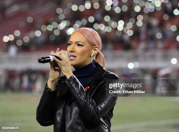 Kaya Jones sings "God Bless America" before a game between the San Diego State Aztecs and the UNLV Rebels at Sam Boyd Stadium on October 7, 2017 in...