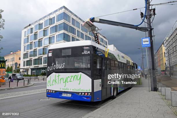 zero emission solaris bus on the charging station - bus charging stock pictures, royalty-free photos & images