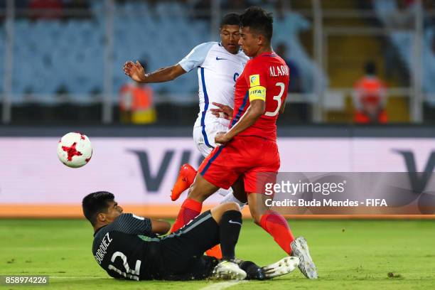 Goalkeeper Julio Borquez and Lucas Alarcon of Chile battle for the ball with Rhian Brewster of England during the FIFA U-17 World Cup India 2017...