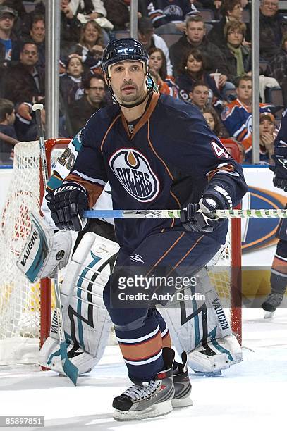 Sheldon Souray of the Edmonton Oilers keeps his eye on the puck against the San Jose Sharks at Rexall Place on April 2, 2009 in Edmonton, Alberta,...