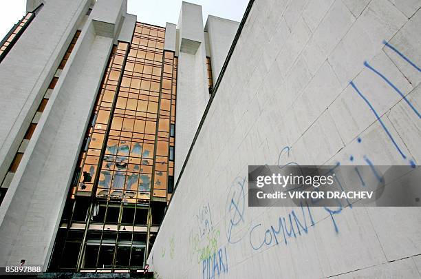 Anti-communist graffiti left by protestors adorns a wall in a vandalized section of the presidential building in Chisinau on April 10, 2009....