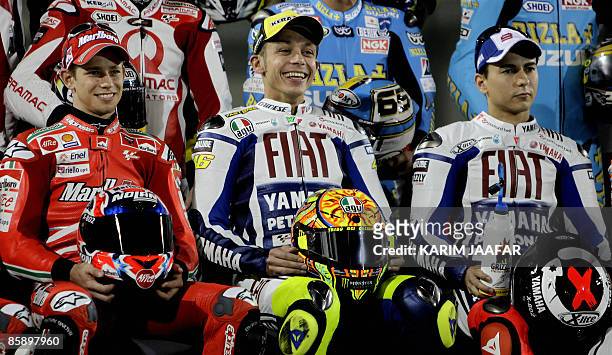 MotoGP riders Casey Stoner of Australia, Valentino Rossi of Italy and Jorge Lorenzo of Spain pose for a photo in the Qatari capital Doha on April 10,...