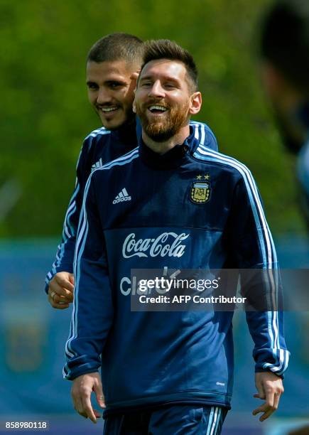Argentina's forwards Lionel Messi and Mauro Icardi laugh during a training session in Ezeiza, Buenos Aires on October 8, 2017 ahead of a 2018 FIFA...