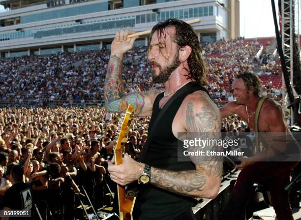 Sevendust guitarist John Connolly throws a drumstick into the crowd as bassist Vince Hornsby performs at KXTE Xtreme Radio's "Our Big Concert 5" at...