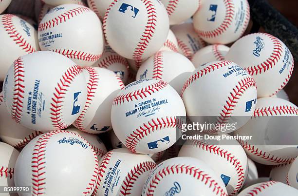 Baseballs are at the ready for warm ups as the Philadelphia Phillies face the Colorado Rockies during MLB action on Opening Day at Coors Field on...