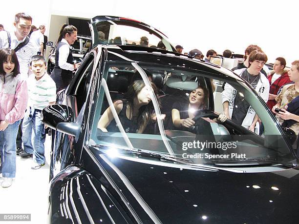 Teenage girls sing Karaoke in a Volkswagen Beetle during the New York Auto Show at Jacob Javits Convention Center on April 10, 2009 in New York City....