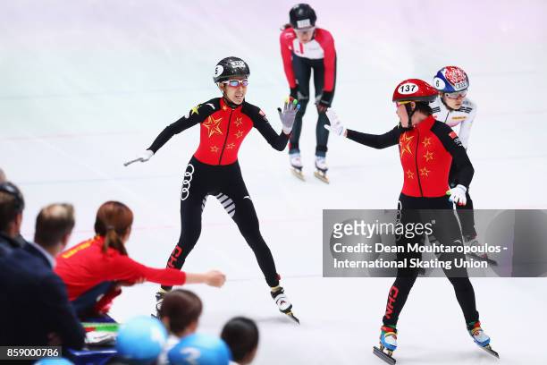 Fan Kexin and Zhou Yang of Team China celebrates after winning gold in the Womens 3000m Relay Final during the Audi ISU World Cup Short Track Speed...