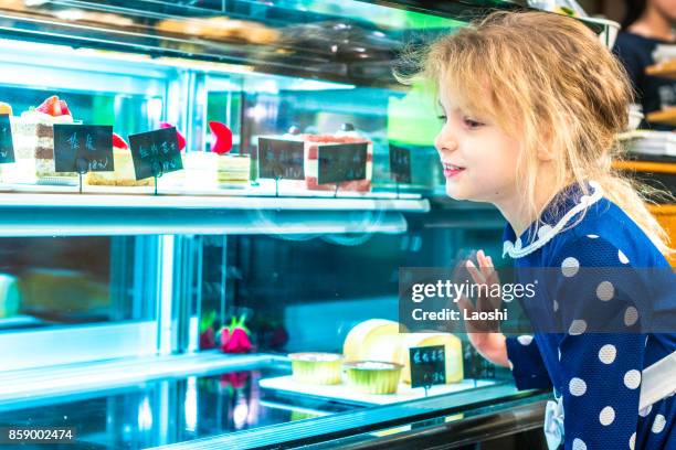 child choosing a cake - laoshi stock pictures, royalty-free photos & images