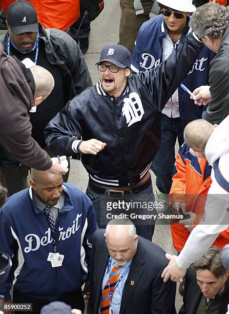 Recording artist Kid Rock high fives fans while leaving the field after the pre game festivities prior to the Detroit Tigers playing the Texas...