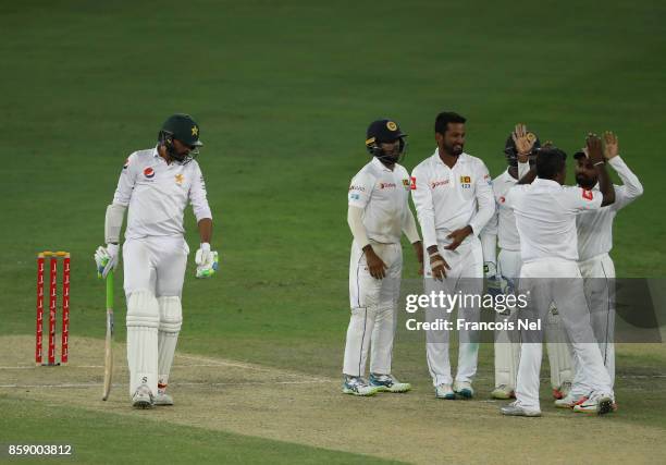 Rangana Herath of Sri Lanka celebrate with teammates after dismissing Mohammad Amir of Pakistan during Day Three of the Second Test between Pakistan...