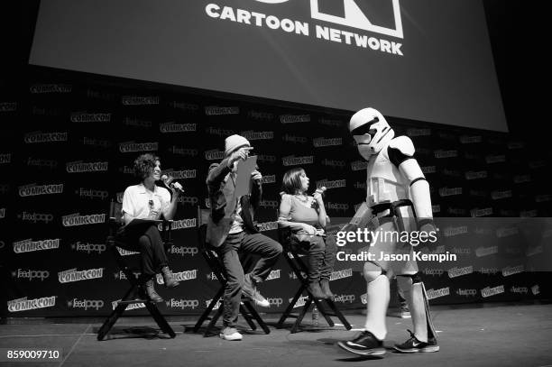 Voice actors Ashly Burch, Greg Cipes, and Tara Strong judge a costume contest onstage during the Cartoon Network Costume Ball during New York Comic...