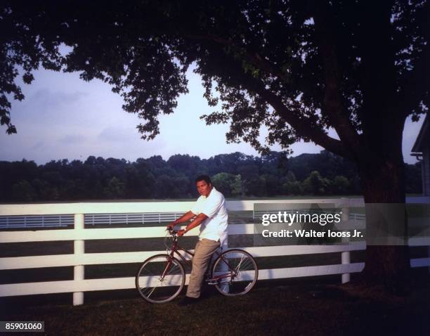 Portrait of former heavyweight champion Muhammad Ali on bicycle at his home. Berrien Springs, MI 9/10/1996 CREDIT: Walter Iooss Jr.