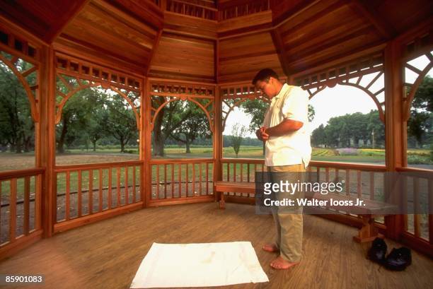 Portrait of former heavyweight champion Muhammad Ali praying in a gazebo at his home. Berrien Springs, MI 9/10/1996 CREDIT: Walter Iooss Jr.
