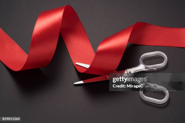 scissors cutting red ribbon - ribbon cutting stock pictures, royalty-free photos & images