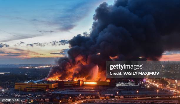 Fire burns at a construction supplies market on the outskirts of Moscow on October 8, 2017. Over 3,000 people were evacuated from the market,...