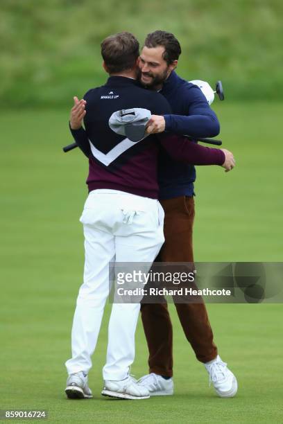 Jamie Dornan, Actor congratulates playing partner Tyrrell Hatton of England on victory during the final round of the 2017 Alfred Dunhill Championship...