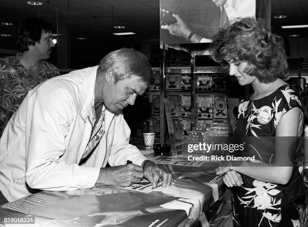 Singer/Songwriter Tom T. Hall signs autographs and meets with fans at Turtle's Records & Tapes in Atlanta Georgia April 03, 1985