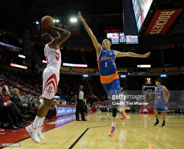Chris Paul of Houston Rockets takes a three point shot defended by Cai Liang of Shanghai Sharks in the first quarter at Toyota Center on October 5,...