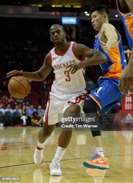 Chris Paul of Houston Rockets drives the ball to the basket defended by Car Liang of Shanghai Sharks in the first half at Toyota Center on October 5,...