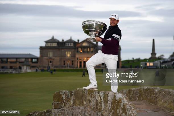 Tyrrell Hatton of England celebrates victory with the trophy on the Swilken Bridge following the final round of the 2017 Alfred Dunhill Championship...