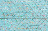 Fishing net texture over light blue wood, maritime background