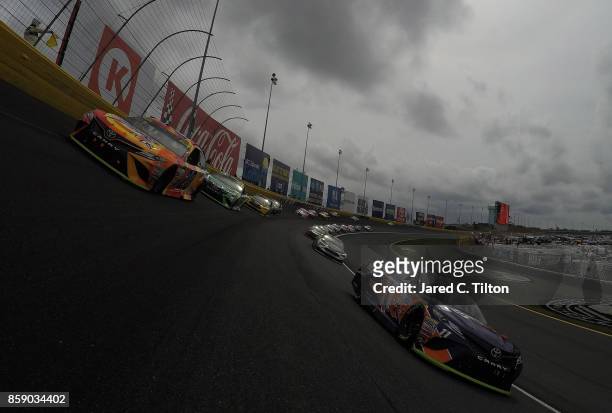 Matt Kenseth, driver of the Tide Pods Toyota, and Denny Hamlin, driver of the FedEx Office Toyota, lead the field at the start of the Monster Energy...