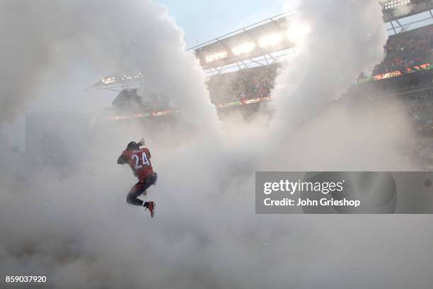 Adam Jones of the Cincinnati Bengals jumps through the smoke while being introduced to the crowd prior to the start of the game against the Buffalo...