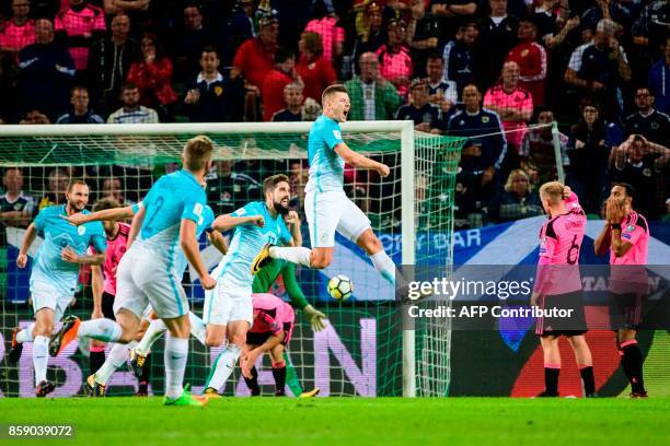 Slovenia's Roman Bezjak celebrates with his teammates after scoring a goal during the FIFA World Cup 2018 qualifier football match between Slovenia...