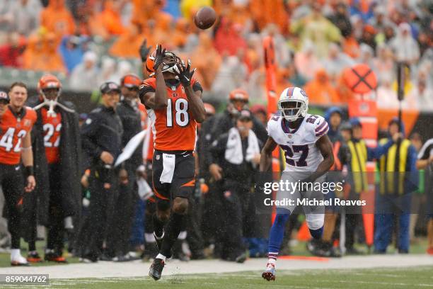 Green of the Cincinnati Bengals catches a pass and runs it in for a touchdown while being defended by Tre'Davious White of the Buffalo Bills during...