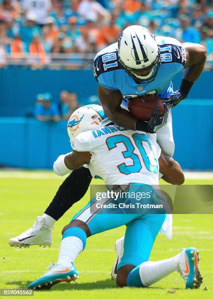 Cordrea Tankersley of the Miami Dolphins tackles Jonnu Smith of the Tennessee Titans in the first quarter on October 8, 2017 at Hard Rock Stadium in...