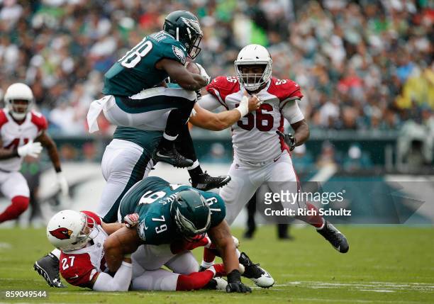 Kenjon Barner of the Philadelphia Eagles hurdles over teammates as he runs for a first down against Karlos Dansby of the Arizona Cardinals during the...