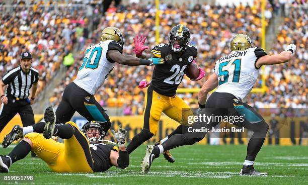 Le'Veon Bell of the Pittsburgh Steelers stiff arms Telvin Smith of the Jacksonville Jaguars as he carries the ball in the first quarter during the...