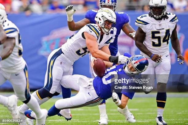 Eli Manning of the New York Giants is sacked by Joey Bosa of the Los Angeles Chargers during the first quarter during an NFL game at MetLife Stadium...
