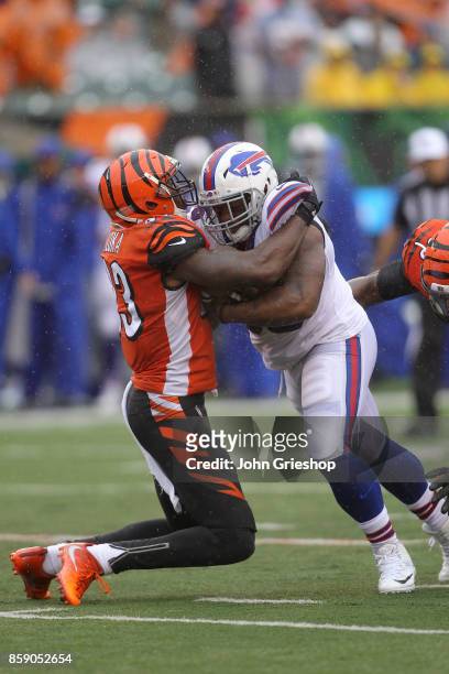 George Iloka of the Cincinnati Bengals attempts to tackle Mike Tolbert of the Buffalo Bills during the first quarter at Paul Brown Stadium on October...