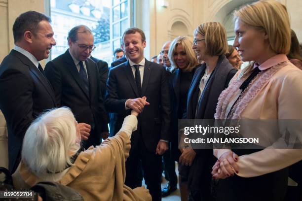 French President Emmanuel Macron , flanked by his wife Brigitte Macron , French Culture Minister Francoise Nyssen , director of the Picasso museum...