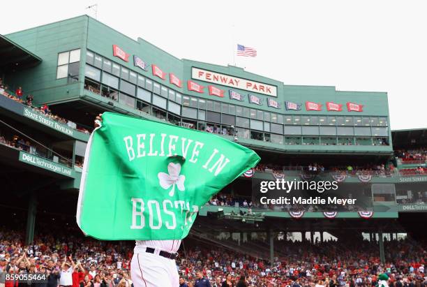 Hanley Ramirez of the Boston Red Sox holds a flag as he takes the field before game three of the American League Division Series between the Houston...