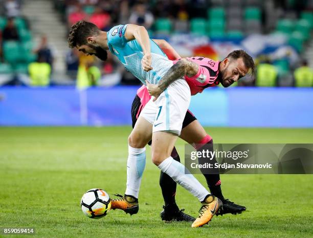 Josip Ilicic of Slovenia in action against Steven Fletcher of Scotland during the FIFA 2018 World Cup Qualifier match between Slovenia and Scotland...